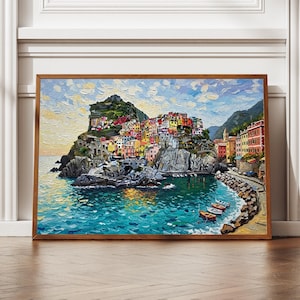 Puede incluir: Pintura al óleo de un pueblo costero italiano con edificios coloridos sobre un acantilado rocoso. La obra presenta una paleta vibrante de azules, amarillos, rojos y verdes, con barcos en el agua turquesa. La pintura está enmarcada.