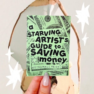 May include: A rectangular sticker with a light green background featuring a collage of US dollar bills. The black text reads: A STARVING ARTIST'S GUIDE TO SAVING MONEY, with the brand name RETROMACCARONI printed at the bottom in black lettering.