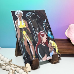 May include: A print featuring five fantasy characters. The characters are drawn in a colorful cartoon style. The characters are a woman with white hair, a woman with dark hair, a woman with red hair, a woman with blue hair, and a woman with blonde hair.