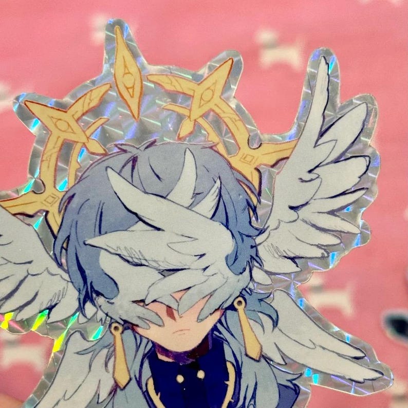 May include: A holographic sticker featuring a blue-haired character with wings covering their eyes. The character is wearing a gold halo and a dark blue and gold outfit.
