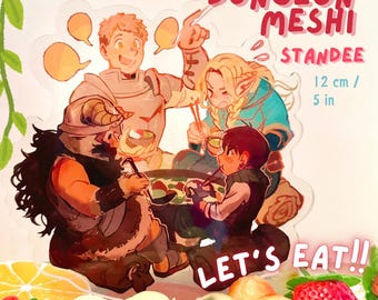 May include: A clear acrylic stand featuring a cartoon illustration of four people enjoying a meal around a hot pot. The illustration is in a colourful anime style. The text "Dungeon Meshi Standee" and "Let's Eat!" are printed on the stand. The stand is 12 cm tall.