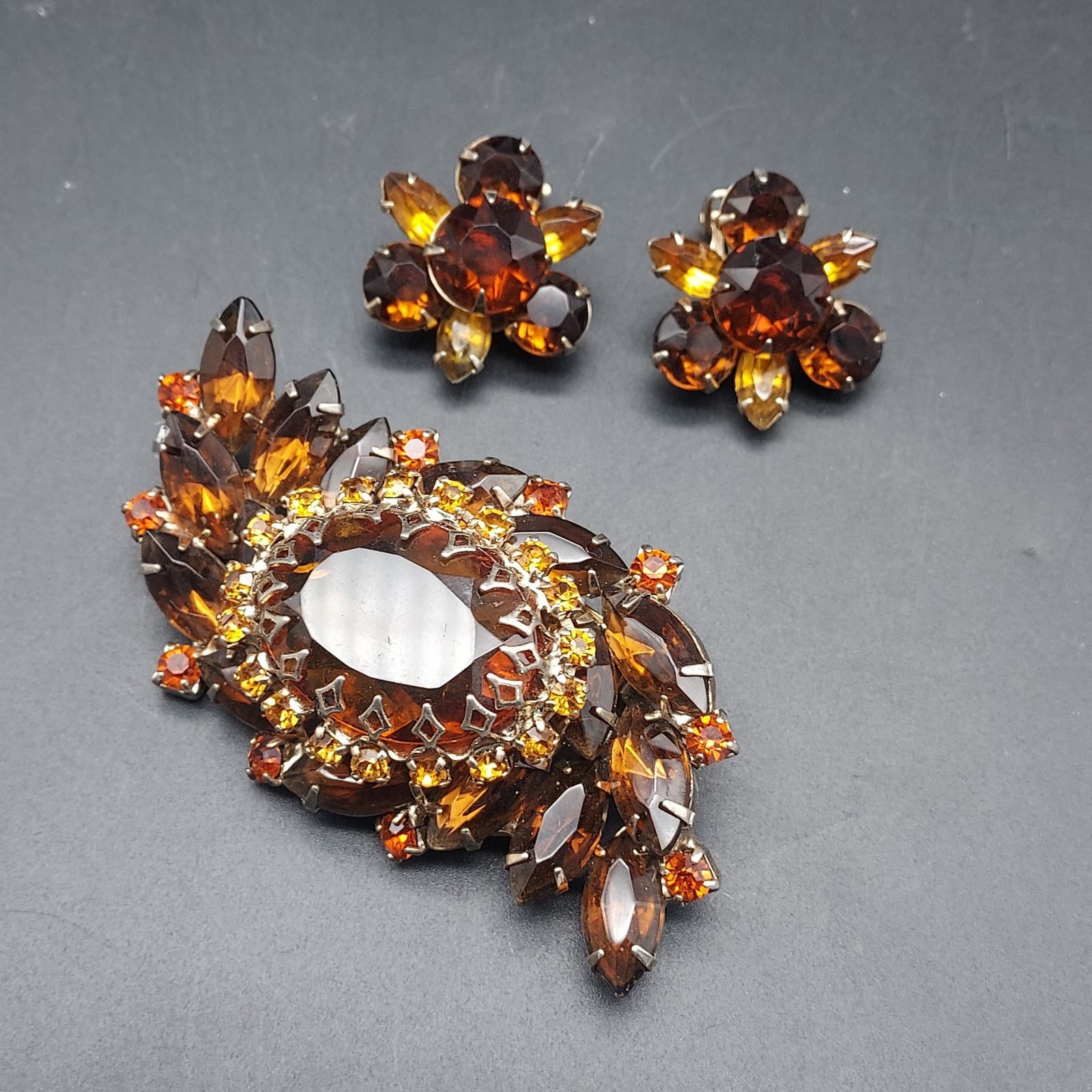 Unsigend Rhinestone Brooch Earrings Set Root Beer Orange Color Navette UV Glow