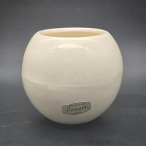 May include: A set of three ceramic mugs with a speckled, matte finish. The mugs are in shades of cream, light gray, and dark gray. Each mug has a simple, minimalist design, perfect for coffee or tea.