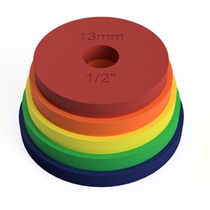 May include: A stack of five circular discs in descending order of size, colored red, orange, yellow, green, and blue. The top red disc features the embossed text 13mm and 1/2 inch, indicating a central hole diameter for these measurement tools.