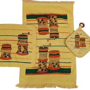 May include: A vintage kitchen set featuring a yellow towel, potholder, and square cloth. The set has a repeating design of salt and pepper shakers with orange and green accents. The towel has a fringed edge.