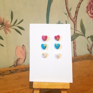 Set of 3 trans pride heart earrings, polymer clay heart shaped studs in pink, blue and white decorated with gold leaf.