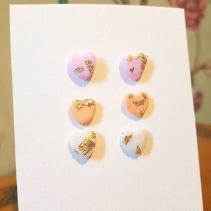 set of 3 pastel lesbian pride heart earrings, pastel pink, orange and white polymer clay lesbian flag stud earrings decorated in gold leaf