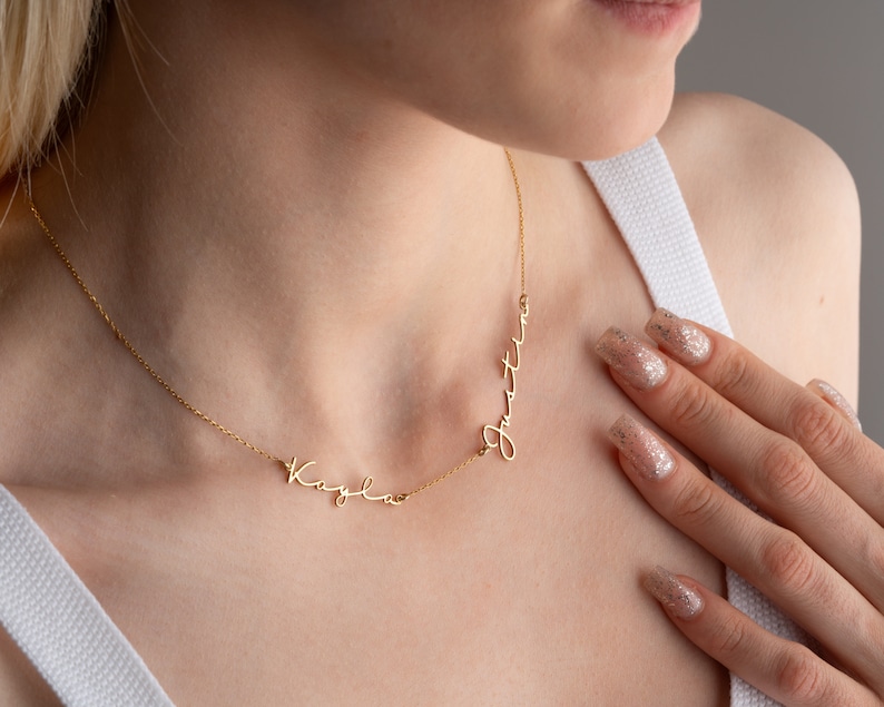 May include: Gold necklace with two names, "Kaylee" and "Justin", written in cursive script.
