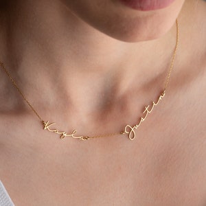 May include: A gold necklace with two names, "Kaylee" and "Justine", written in cursive script.