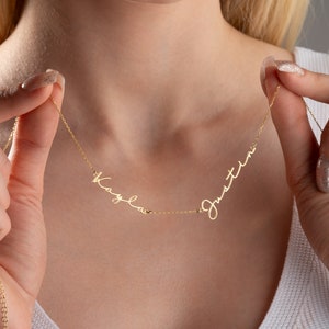 May include: Gold necklace with two names, "Kayla" and "Justin", written in cursive script.
