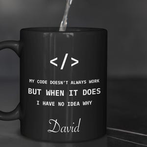 a black coffee mug with a programming code on it