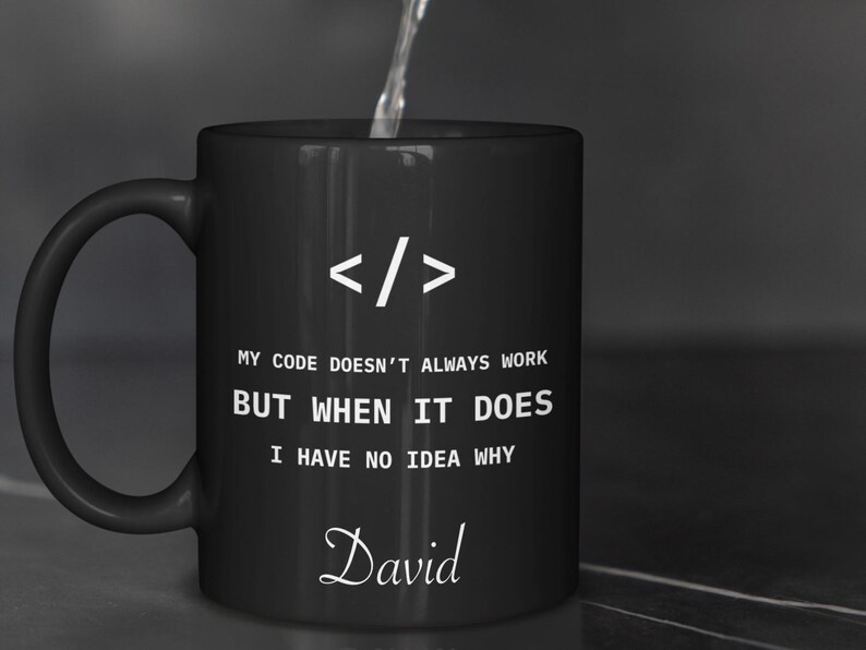 a black coffee mug with a programming code on it