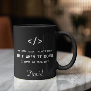 a black coffee mug sitting on top of a marble table