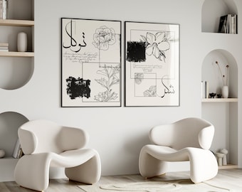 May include: Two black and white framed prints with floral illustrations and Arabic calligraphy. The prints are hanging on a white wall above two white chairs.