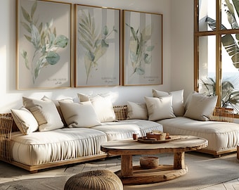 May include: A white sectional sofa with multiple pillows sits in a living room with a wooden coffee table and a woven ottoman. Three framed prints with green foliage and Arabic text hang on the wall behind the sofa.