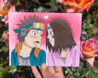 May include: A hand-painted canvas featuring two anime characters, a male with brown hair and a female with long brown hair, looking at each other with a heart above their heads. The background is pink with white sparkles.