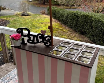 Folding charcuterie cart with customizable top. Pink striped. 48x23x36”h
