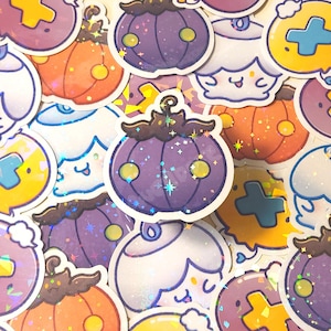 May include: A collection of colorful stickers featuring cartoon-style designs. The stickers include images of pumpkins, ghosts, and other Halloween-themed graphics. The stickers have a holographic, glittery finish, adding a sparkling effect to the designs.