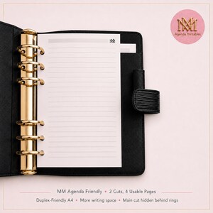May include: A black leather-textured binder featuring a gold-toned six-ring mechanism. Inside, a white lined paper insert displays the text MM at the top. A black strap closure is attached to the right side of the binder cover.