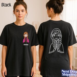 A woman wearing a black t-shirt with a cartoon character printed on the back.