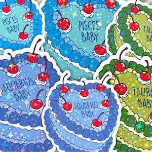 May include: Five holographic stickers featuring astrological signs with the text "Pisces Baby", "Taurus Baby", and "Aquarius Baby". Each sticker features a cake with cherries and a sparkly background.