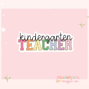 May include: A colorful, glittery sticker that says "kindergarten TEACHER" in rainbow colors with a gold glitter outline. The sticker is on a pink background.