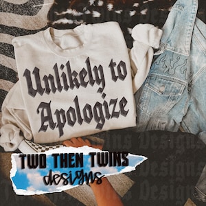 May include: A cream-coloured crewneck sweatshirt featuring the black text Unlikely to Apologize in a bold gothic font, positioned next to a light blue denim jacket with a stitched flame pattern and a checkered slip-on shoe.