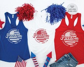 May include: Three tank tops with the text "Freedom Squad Since 1776" and a red, white, and blue American flag design. The tank tops are in blue, white, and red.