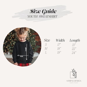 The image is a size guide for a youth sweatshirt, featuring a young girl wearing a black sweatshirt and a Christmas tree in the background.