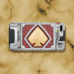 May include: A silver and red phone case with a gold spade design. The case has a textured, metallic look and features a detailed design.