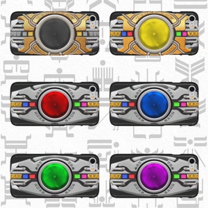 May include: Five different colored phone cases with a silver and black design. Each case has a different colored circle in the center. The circles are yellow, red, blue, green, and purple.
