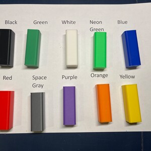 May include: A set of 10 small plastic blocks in various colors, including black, green, white, neon green, blue, red, space gray, purple, orange, and yellow.
