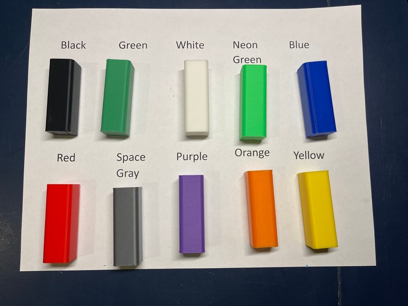 May include: A set of 10 small plastic blocks in various colors, including black, green, white, neon green, blue, red, space gray, purple, orange, and yellow.