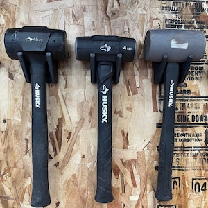 May include: Three black and gray  Husky brand  hammers with a wolf logo. The hammers are 45 oz, 4 lbs, and 4 lbs.