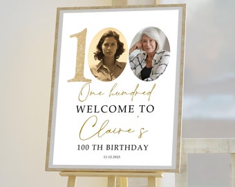 May include: A white sign with gold lettering and a photo of two women. The sign reads "One hundred, Welcome to Claire's 100th Birthday 12.12.2021".