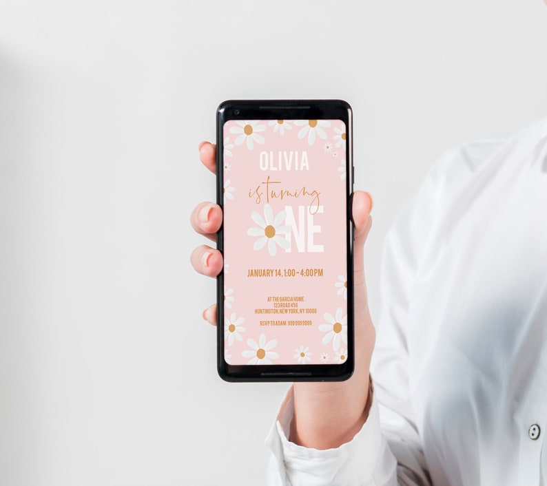 May include: A pink and white digital invitation with white daisies and gold text. The text reads "Olivia is turning one" and "January 14, 1:00-4:00 PM".