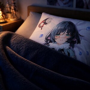 May include: A rectangular white pillowcase featuring a printed anime-style illustration of a character with dark hair, teal eyes, and cat-like ears, accented by floating blue droplets and a small red and white circular emblem on the upper left corner.