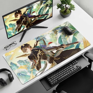 May include: A rectangular desk mat featuring a vibrant anime-style illustration of a dark-haired character in ornate armour holding a long staff. The artwork displays a lush, mountainous landscape with flowing fabric elements in shades of green, gold, and blue.