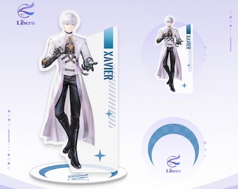 May include: An acrylic standee featuring a white-haired character named Xavier in a long white coat, black trousers, and black boots. The figure stands on a circular base with the Libero logo. A vertical panel displays the name XAVIER in blue text.