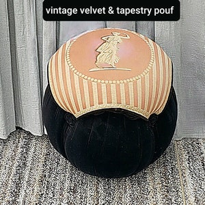 May include: A vintage velvet and tapestry pouf with a pink and white striped top. The top features a raised design of a woman in a dress.