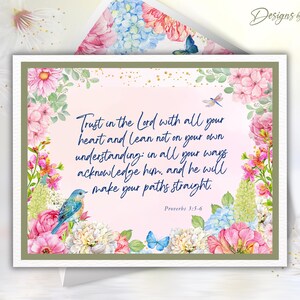 May include: A greeting card with a floral design and the text "Trust in the Lord with all your heart and lean not on your own understanding." The card features pink, blue, and white flowers, a blue bird, and butterflies.