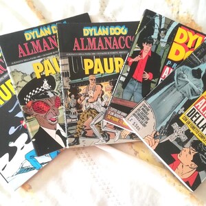May include: A collection of five Dylan Dog Almanacco della Paura comic books featuring illustrated covers with bold yellow and red text. The covers display various graphic scenes including a police officer, a hooded figure, and a man.