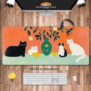 May include: A colorful desk mat with an orange background featuring four cats and a vase of flowers. The vase is green with white flowers. The cats are black, white, and black and white. The mat measures 36x16 inches (90x40 cm).