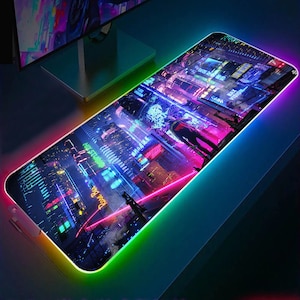 May include: A neon cityscape design mouse mat with a rainbow-coloured LED light border. The mouse mat features a futuristic city scene with neon lights and skyscrapers.