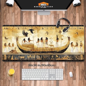 May include: A large, rectangular mouse mat with a gold and black design featuring an Egyptian boat with hieroglyphics. The mouse mat measures 36x16 inches (90x40 cm).