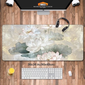 May include: A large, rectangular mousepad with a floral design featuring white lotus flowers on a light gray background with gold accents. The mousepad measures 36x16 inches (90x40 cm).