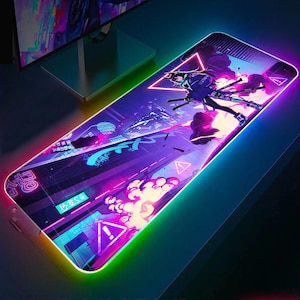 May include: A neon-coloured gaming mouse mat with a futuristic city scene and a character holding a sword. The mouse mat has a rainbow-coloured border.