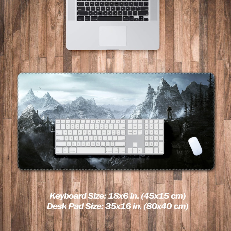 K&ouml;nnte beinhalten: Eine schwarze und wei&szlig;e Gaming-Mausmatte mit einer Bergkette und einer einsamen Figur, die auf einem Gipfel steht. Die Mausmatte ist 35 Zoll mal 16 Zoll (80 cm mal 40 cm) gro&szlig;.