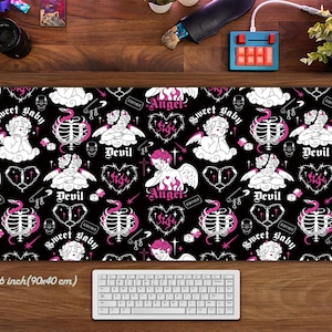 May include: Black and white mouse mat with a repeating pattern of cherubs, skulls, and the words "Sweet Baby", "Devil", and "Angel". The mouse mat is 90 cm by 40 cm.