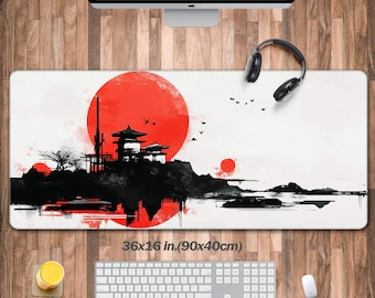 May include: A rectangular desk mat with a Japanese-inspired design. The mat features a large red sun, a black silhouette of a temple, and a landscape. The mat measures 36 x 16 inches.